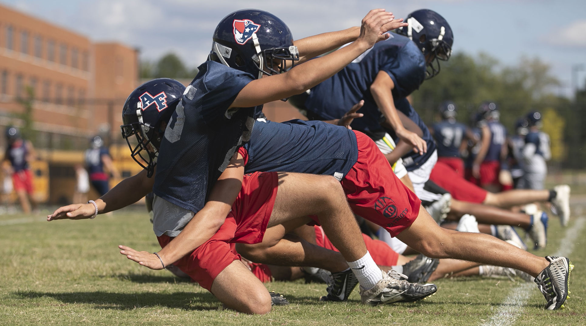Apex Friendship High School players work on their tackling technique without pads during practice on Sept. 18, 2019 in Apex, N.C. Coach Adam Sanders has adopted no contact practices as a way to cut down on injures.